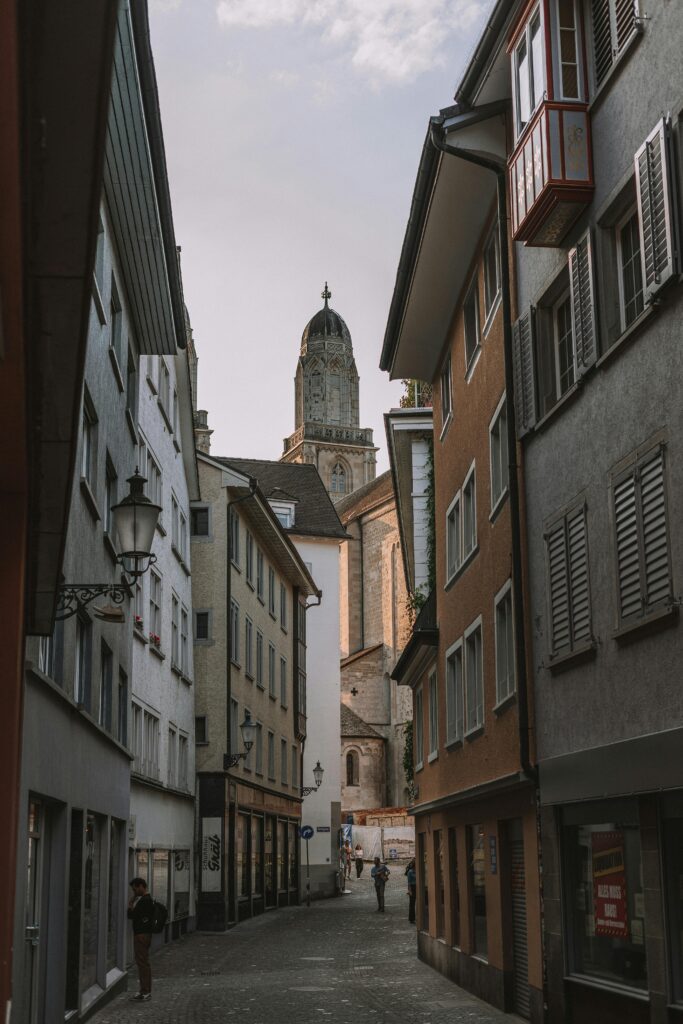 Narrow street in Zurich’s Old Town with a view of the church, featured in this Zurich travel guide.