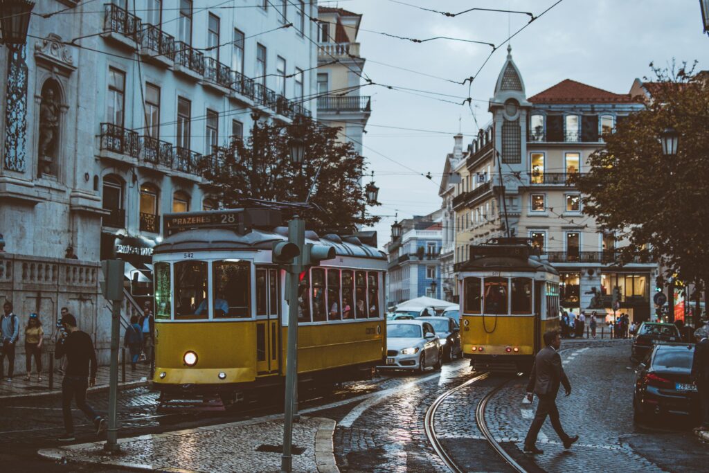  Lisbon travel guide 2024 - Classic yellow trams passing through the historic streets of Lisbon, Portugal.