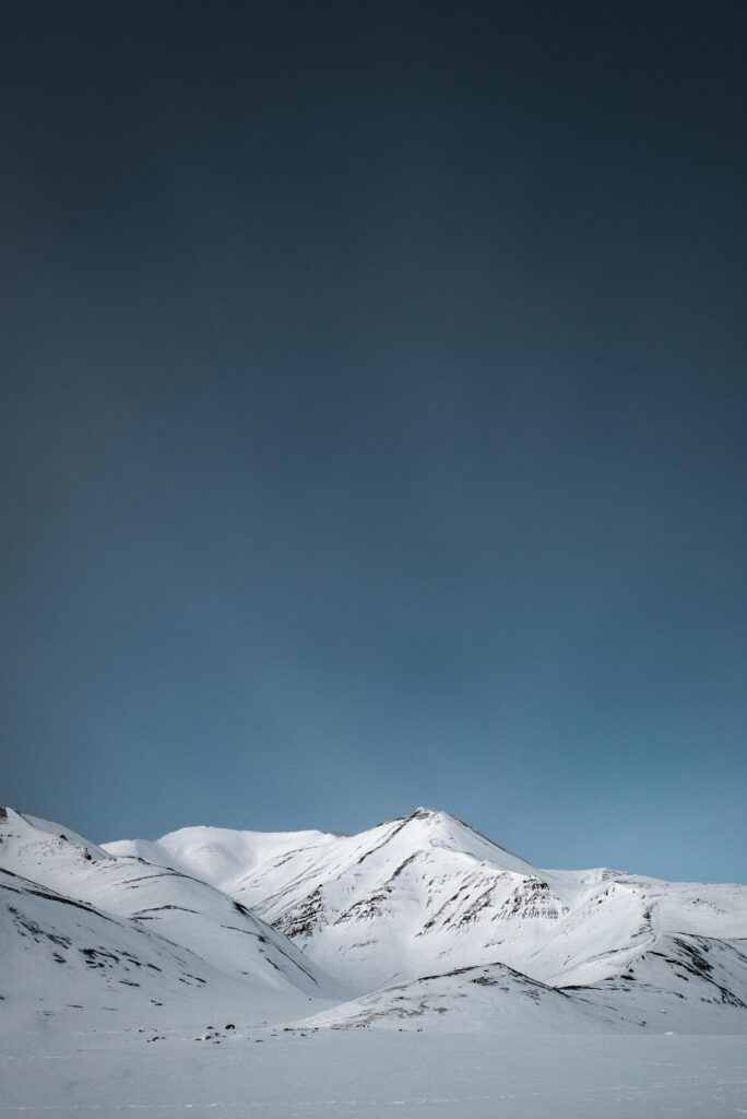 Snow-covered mountains in Svalbard, featured in our Svalbard travel guide.