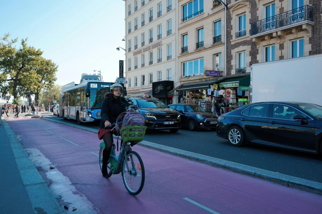 Woman biking in a lively street in Lille, France. Lille Travel Guide