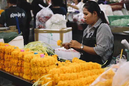 Woman preparing flowers at the Wazemmes Market in Lille, France. Lille Travel Guide