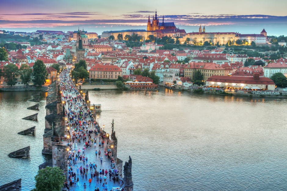 People Walking on Concrete Bridge. Prague travel guide