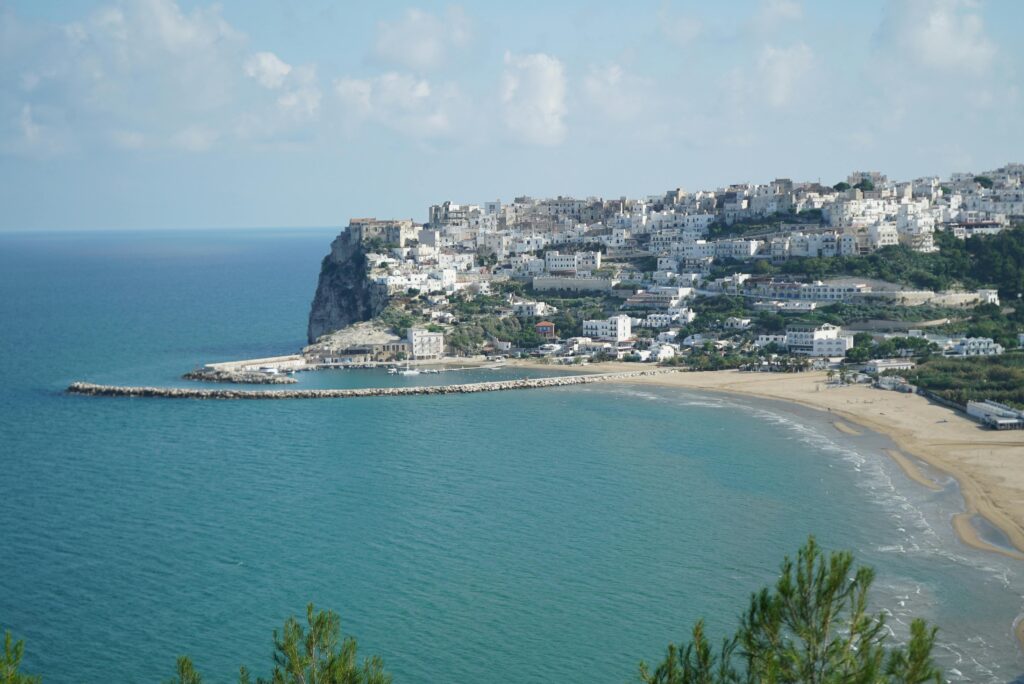 A picturesque coastal town on a cliff overlooking the Mediterranean Sea in Italy.